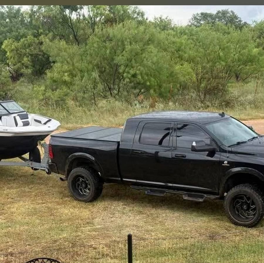A boat on its trailer, in tow behind a pickup near Lake Brownwood